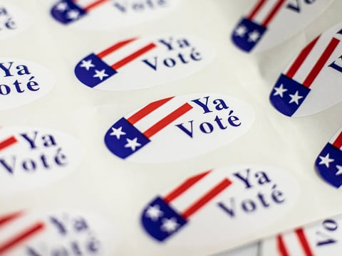Voting stickers are given to voters at the Alexander Hamilton Middle School voting center in Fresno on Nov. 8, 2022.