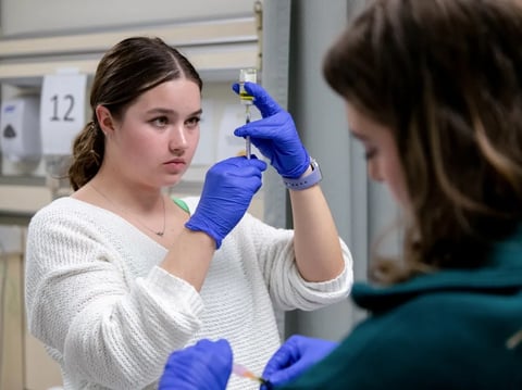 Nursing students Ashley Jensen, left, and Courtney Houtz practice injection procedures in the clinical skills lab at University of San Francisco in San Francisco, Calif. on Oct. 9, 2023. Health care is one of the areas that has added jobs since 2022.