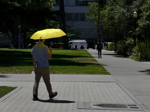 A man shields himself from the sun in Sacramento, Calif., Tuesday, July 2, 2024.