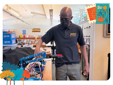 Flip Kirby shows the robots that students can program at the Music Science Group at Bowling Green Elementary School.