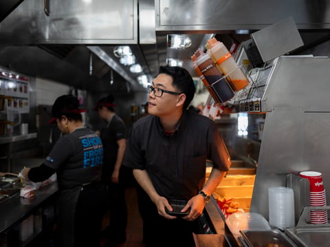 Lawrence Cheng, whose family owns seven Wendy's locations south of Los Angeles, works in the kitchen at his Wendy's restaurant in Fountain Valley, Calif., June 20, 2024.