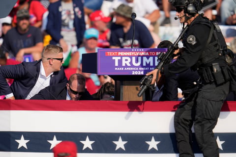 Republican presidential candidate former President Donald Trump is surrounded by U.S. Secret Service at a campaign event in Butler, Pa., on Saturday, July 13, 2024.
