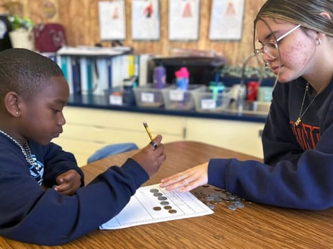 Bullard High School senior Isabell Coronado works with Gibson Elementary first grader Mayson Lydon on March 15, 2024, as part of Fresno Unified's Teacher Academy Program.