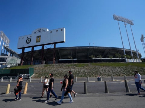 Fans walk outside of the Oakland Alameda Coliseum before a baseball game between the Oakland Athletics and the San Francisco Giants in Oakland, Calif., Saturday, Aug. 5, 2023.