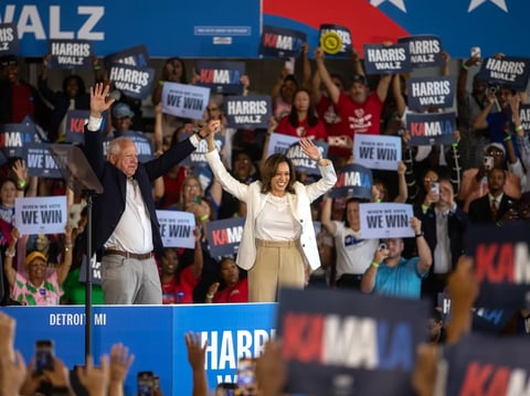 Vice President Kamala Harris and Minnesota Gov. Tim Walz walk on stage during Harris' presidential campaign rally at the Detroit Metropolitan Wayne County Airport in Romulus, Mich., on Aug. 8, 2024.