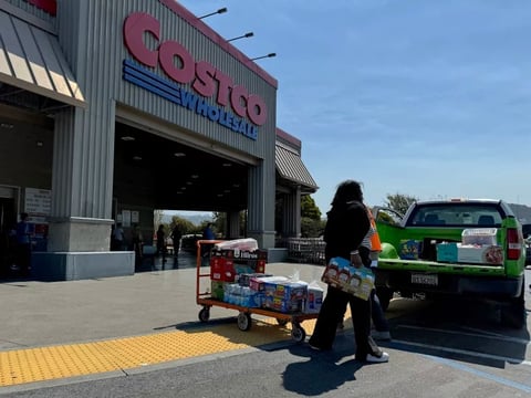 A customer loads a pickup truck after shopping at a Costco store on July 11 in Richmond, Calif.