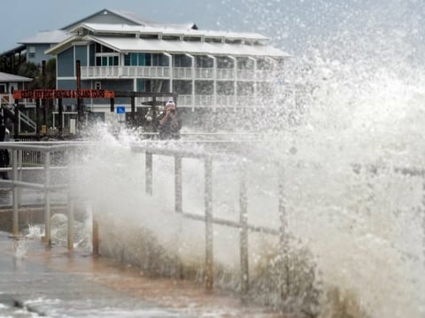Surf from Tropical Storm Debby breaks over a sea wall in Cedar Key, Fla., in August 2024. Abnormally hot ocean water is contributing to a very active Atlantic Hurricane season.