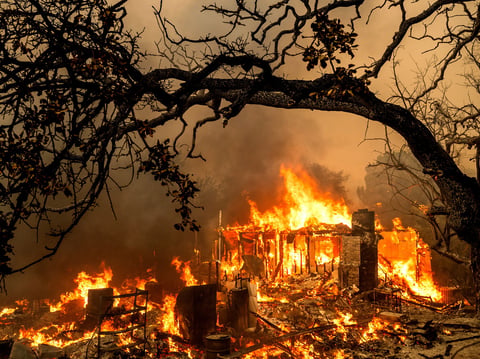 Flames consume a structure on Bessie Lane as the Thompson Fire burns in Oroville, Calif., July 2, 2024.