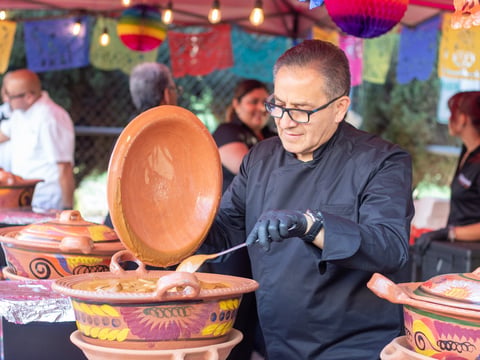Cielito Lindo chef Ramiro Alarcon checks one of eight baroque moles created for the festival Saturday, Aug. 24, 2024, in Sacramento.