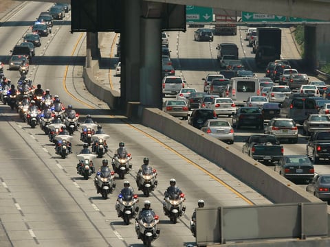 California Highway Patrol officers ride during a funeral procession on Wednesday, June 30, 2010, in Los Angeles.