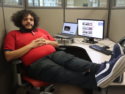 Christian Gates, also known as The Philharmonik, sits at a desk at CapRadio’s station in Sacramento, Calif.
