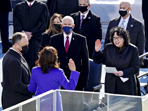 Supreme Court Justice Sonia Sotomayor (right) administers the oath of office to incoming Vice President Kamala Harris in front of the U.S. Capitol on Jan. 20, 2021, as outgoing Vice President Mike Pence (wearing blue mask) watches.