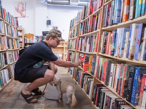 Logan Hansen, 28, peruses the fiction aisle Thursday, Aug. 22, 2024, at Beers Books in Sacramento.