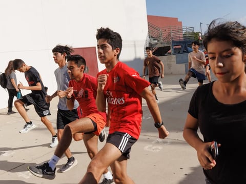 Students stretch before cross-country practice at Norte Vista High in Riverside on Sept. 19, 2024.