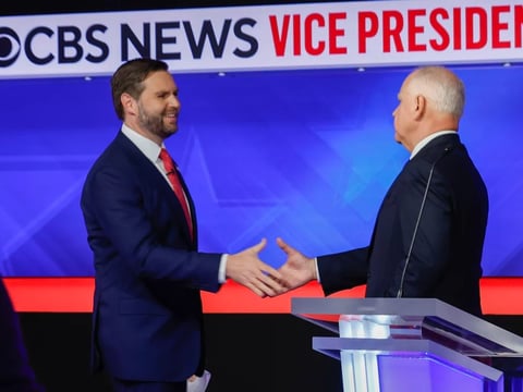 Minnesota Gov. Tim Walz and Ohio Sen. JD Vance shake hands after the vice presidential debate at the CBS Broadcast Center on Tuesday in New York City.