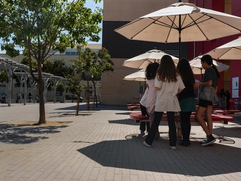 Students play in the shade during recess in the schoolyard of La Escuelita Elementary School in Oakland, on Sept. 23, 2024. Many California schools have no functioning air conditioning.
