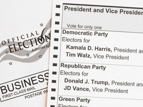 In this photo illustration, an absentee-voter mail-in ballot shows the names of the Democratic and Republican presidential and vice presidential candidates in the 2024 election.