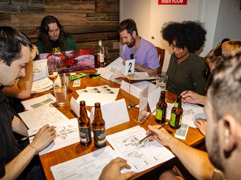 Guests play Dungeons & Dragons at There and Back Cafe on Aug. 22.