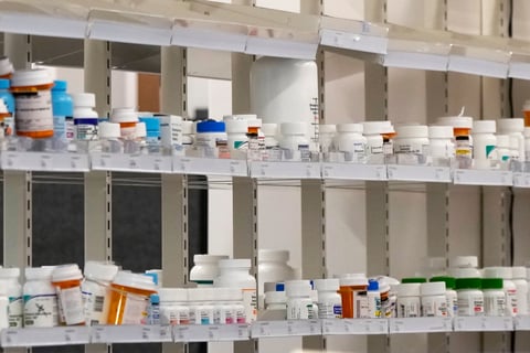 Bottles of prescription medication sit on on shelves in a pharmacy at a Walgreens pharmacy store in Deerfield, Ill., Thursday, July 25, 2024.