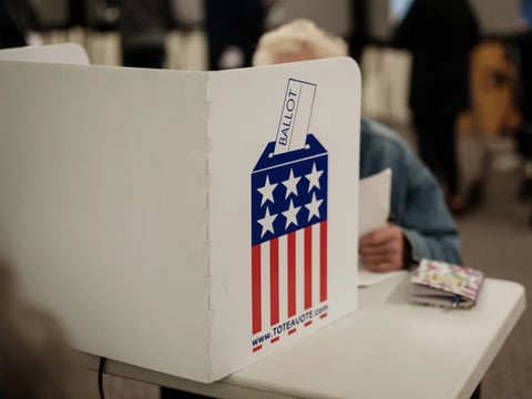 A man votes at a public library turned into an early voting polling station in Black Mountain, N.C., on Oct. 29.