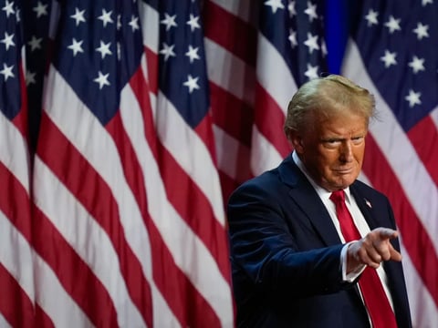 Republican presidential nominee former President Donald Trump points to the crowd at an election night watch party in West Palm Beach, Fla. on Nov. 6, 2024.
