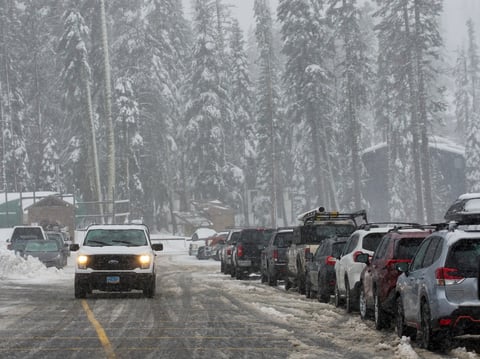 Snow comes down on trees and a road during a storm Thursday, Nov. 21, 2024, at Sugar Bowl Ski Resort in Norden, Calif.