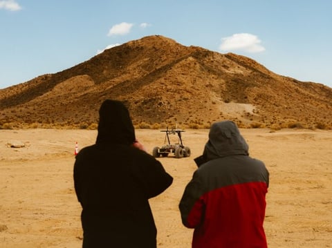 Two people admiring the Helelani rover.