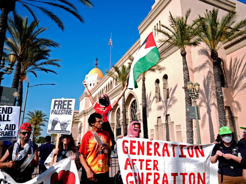 Pro-Palestinian demonstrators rally at the Shrine Auditorium where a commencement ceremony for graduates from Pomona College was being held Sunday, May 12, 2024, in Los Angeles.