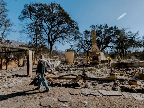 A man surveys the charred remains of his home, destroyed in the Eaton Fire on Jan. 8. The house, built in 1902 and owned by his family for generations, was slated for a remodel to pass down to the next generation.
