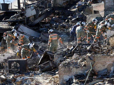 An urban search and rescue team from Mexico combs through the ruins of a beachfront house searching for victims in the aftermath of the Palisades Fire in Malibu, Calif., on Tuesday.