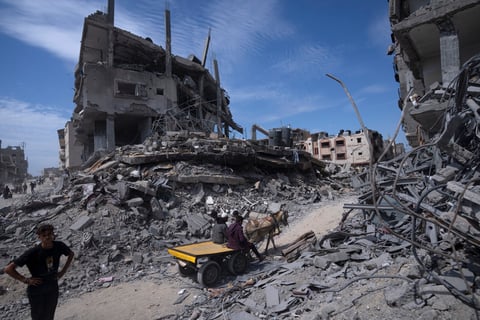 Palestinians salvage what they can from the destruction left by Israeli troops in Khan Younis, southern Gaza Strip, on April 8, 2024.