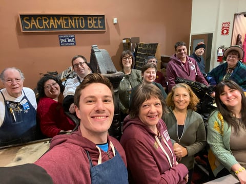 The Sacramento History Museum team taking a selfie in the print shop exhibit, January 15, 2025