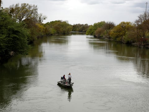 People fish in the Sacramento-San Joaquin River Delta's Elk Slough near Courtland, Calif., Tuesday, March 24, 2020.