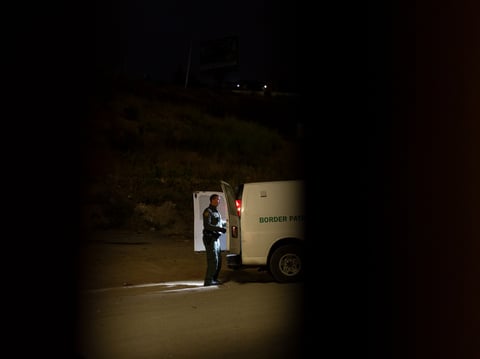 A Border Patrol agent loads migrants seeking asylum into a van to be processed, Tuesday, June 4, 2024, in San Diego.