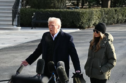President Trump, shown here standing with first lady Melania Trump, speaks to reporters at the White House before leaving for his trip to North Carolina and California on Jan. 24.