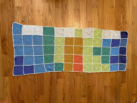 Crochet granny squares representing 2024 weekly average temperatures in Sacramento, produced as part of CapRadio's temperature blanket.