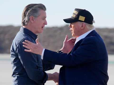 President Donald Trump talks with California Gov. Gavin Newsom after arriving on Air Force One at Los Angeles International Airport in Los Angeles, Friday, Jan. 24, 2025.