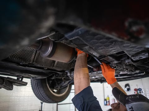 A mechanic works on a vehicle in Fresno in 2022. California's lawmakers are scrambling to update California's lemon law that gives car owners the right to demand car companies fix or replace defective vehicles under warranty.
