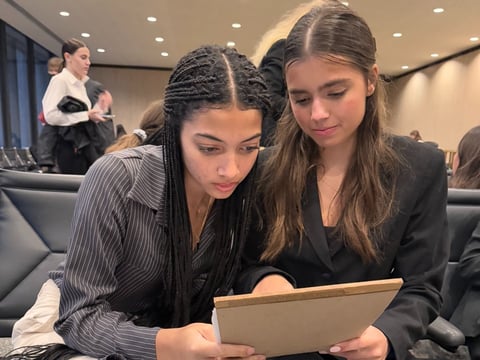 Mackenzie Thomas (L) and Juliet Shah (R) preparing for their mock trial case before entering the courtroom.