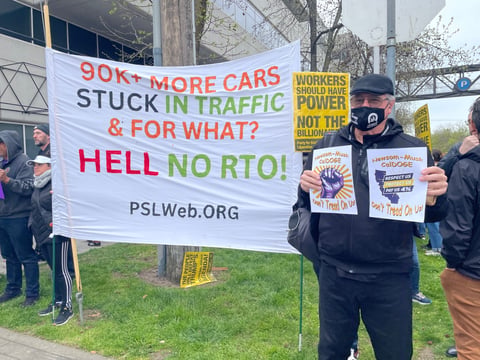 Protesters hold signs at a rally against Newsom’s executive order requiring state employees to work in the office at least 4 days per week. March 12, 2025.
