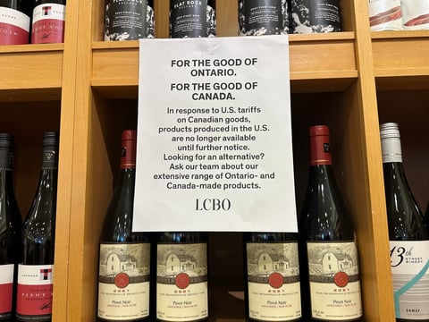 A sign is posted on a wine shelves at an LCBO, the government-run liquor stores where most wine and spirits in the province are purchased, Sunday, March 9, 2025, in Toronto.