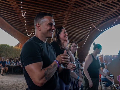 Joe Hunter, a Sacramento fire captain and Survivor contestant, watches an episode with his wife at a watch party at Drake’s Barn in West Sacramento on April 9, 2025.