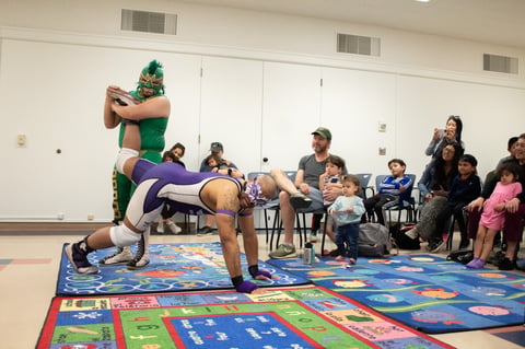 California Championship Wrestlers Nahual (left) and Blaqlight demonstrate an ankle lock Saturday, April 12, 2025, at Rancho Cordova Library.