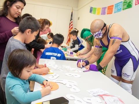 California Championship Wrestlers Blaqlight (far right) and Nahual decorate custom masks Saturday, April 12. 2025, at Rancho Cordova Library at 9845 Folsom Blvd in Sacramento.
