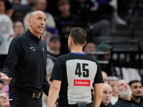 Sacramento Kings interim head coach Doug Christie, left, talks with referee Brian Forte (45) during the second half of an NBA play-in tournament basketball game against the Dallas Mavericks, Wednesday, April 16, 2025, in Sacramento, Calif.