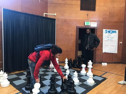 Mathis Sheridan, 19, sets up a game at a “youth pop-up” in early 2020. These events were partially funded by Measure U, and city leaders say they’ve been key to preventing teen violence.