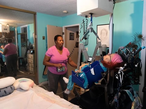 Longtime caretaker Marie Locoh helps Cynde Soto at her home in Long Beach. Soto would lose her MediCal coverage under a proposal by Gov. Gavin Newsom to impose asset limits of $2,000 per person on Medi-Cal eligibility.