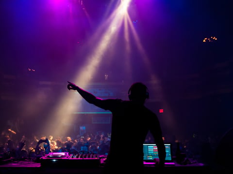 Silhouette of a DJ performing at a concert. (Angelina/stockadobe.com)