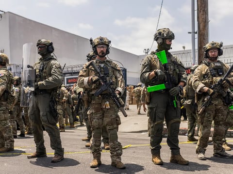 Federal Bureau of Investigation agents face off against protesters during an ICE raid at Ambiance Apparel in Downtown Los Angeles on June 6, 2025.