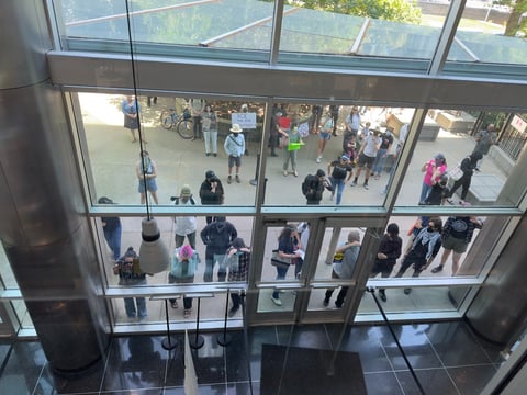 Protesters attempt to enter the John Moss Federal Building after it was placed on lockdown Thursday. Access was restricted following an immigration enforcement action that led to the detention of a man while exiting immigration court.